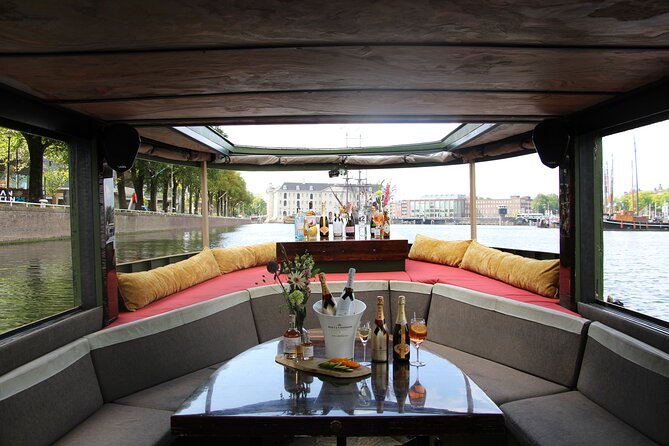 Amsterdam: Luxury Boat Cruise Unlimited Cocktails, Beers & Wines - Evening lights, rain, and cold-weather comfort