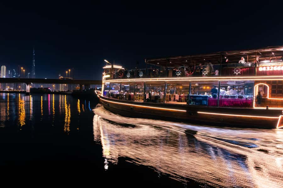Dubai: Luxury Canal Dinner Cruise with Optional Transfers - A glass-enclosed dhow with Dubai’s lights outside