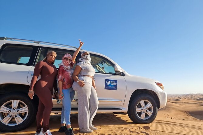 Dubai Red Dunes with Sandboarding, Camel Ride, Falcon & VIP Camp - Sandboarding across the dunes