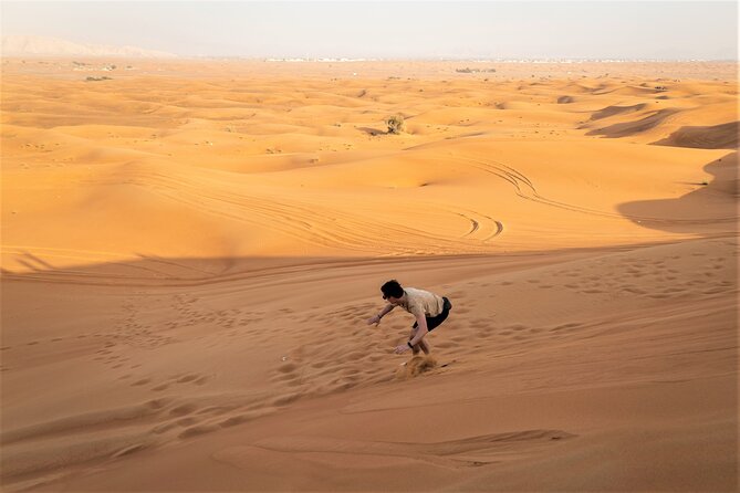 Dubai Red Dunes with Sandboarding, Camel Ride, Falcon & VIP Camp - A short camel ride at twilight