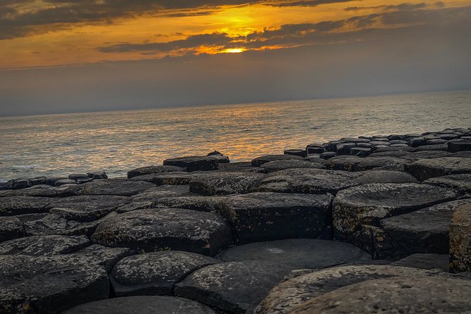 Giants Causeway Tour from Belfast + FREE Belfast Mural Tour - Dunluce Castle above the sea