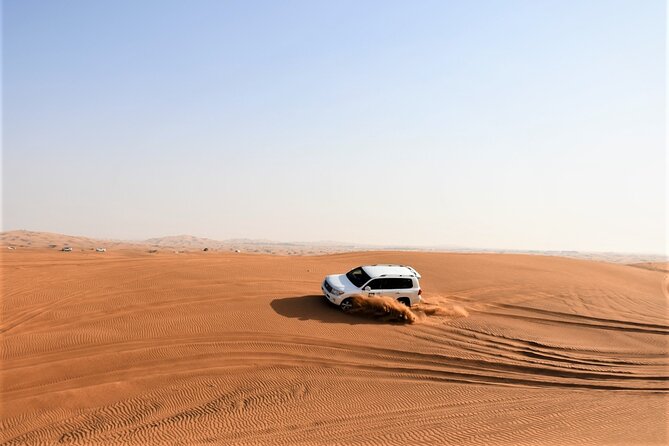Premium Red Dunes Bashing with Quad Bike, Camel, Falcon &VIP Camp - Sandboarding is short, simple, and optional in spirit