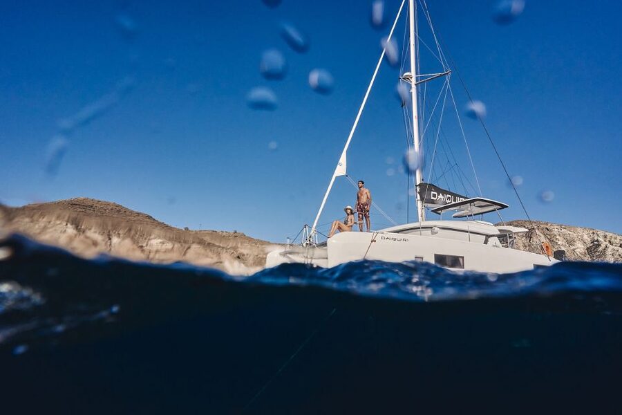 Santorini: Caldera Luxury Catamaran Cruise w/ Meal & Drinks - Red Beach, where the cliffs do the talking