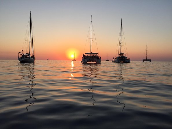Santorini Luxury Catamaran Sunset Cruise with BBQ, Drink and Transfer - The sunset finale