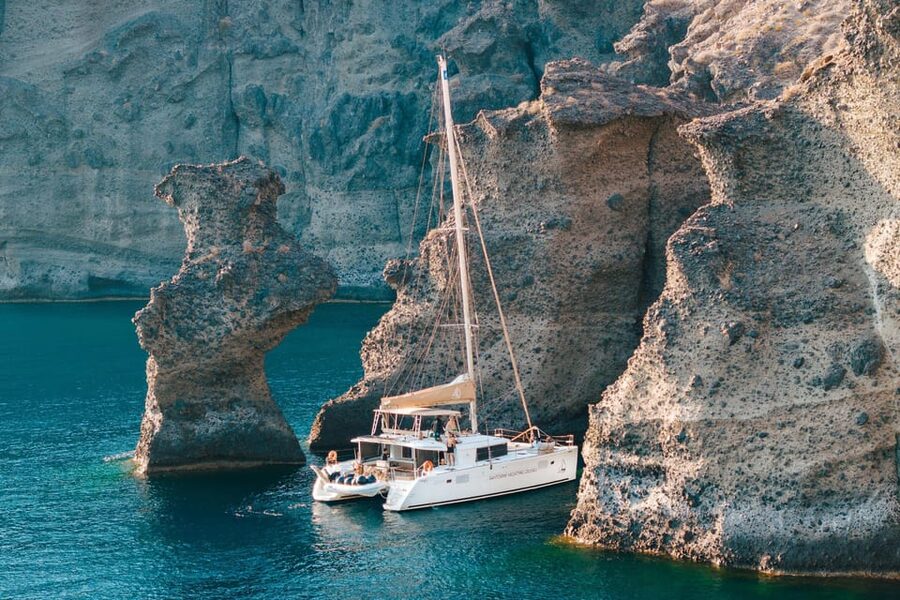 Santorini: Luxury Sunset Cruise with Dinner, BBQ, and Drinks - Entering the caldera and reaching the hot springs