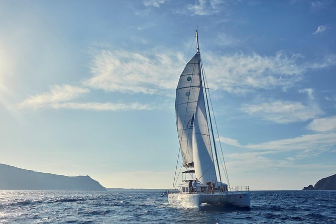 Santorini Sunset Luxury Sailing Catamaran Cruise with BBQ, drinks, transfer - White Beach combines swimming and lunch